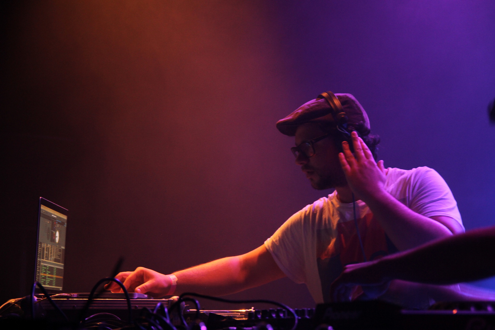 In the booth — flat cap and headphones