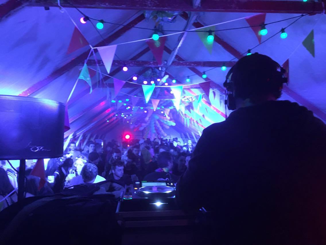 Open-air guinguette set under bunting lights